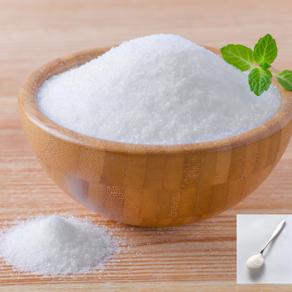 A bowl and spoon overflowing with sugar, depicting sugar addiction.